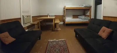 a living room with a couch and a bunk bed at Aunt Jane's Yellow House in Put-in-Bay