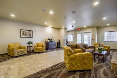 a lobby with couches and chairs in a waiting room at Cobblestone Hotel & Suites - Orrville in Orrville