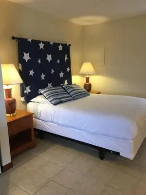 a bedroom with a large bed with an american flag on it at The North Star Inn in Corinth