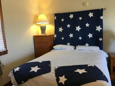 a bedroom with a bed with stars on it at The North Star Inn in Corinth