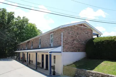 a brick building on a street next to a sidewalk at The North Star Inn in Corinth