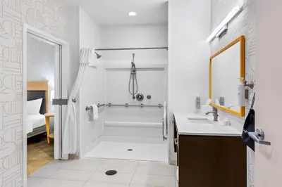 a white bathroom with a shower and a sink at Home2 Suites By Hilton Youngstown in Youngstown