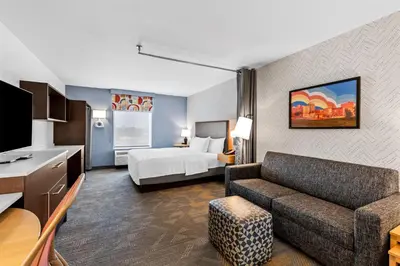 a hotel room with a couch and a bed at Home2 Suites By Hilton Youngstown in Youngstown