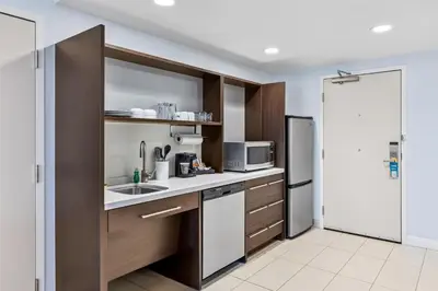 a kitchen with a sink and a refrigerator at Home2 Suites By Hilton Youngstown in Youngstown