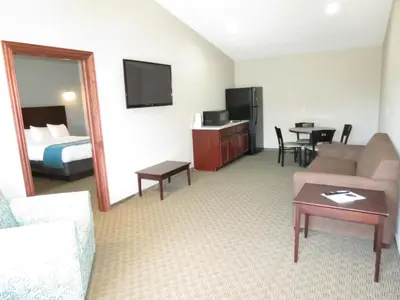 a hotel room with a couch and a bed at Edgewater Hotel and Suites in Put-in-Bay