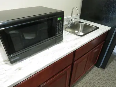 a microwave sitting on a counter next to a sink at Edgewater Hotel and Suites in Put-in-Bay