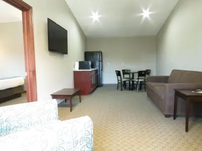 a living room with a couch and a table at Edgewater Hotel and Suites in Put-in-Bay