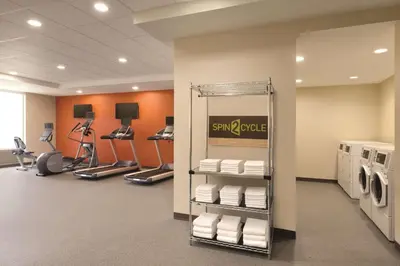 a room with a gym with washing machines and towels at Home2 Suites By Hilton Columbus Dublin in Dublin
