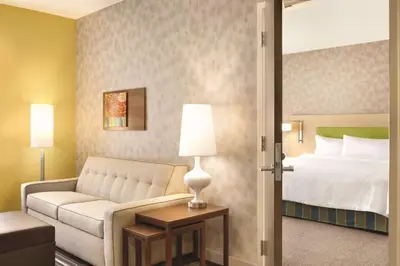 a hotel room with a bed and a couch at Home2 Suites By Hilton Columbus Dublin in Dublin