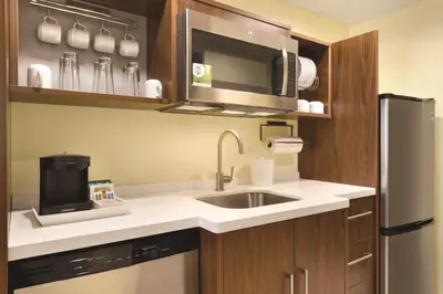 a small kitchen with a sink and a microwave at Home2 Suites By Hilton Columbus Dublin in Dublin
