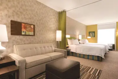 a hotel room with a bed and a couch at Home2 Suites By Hilton Columbus Dublin in Dublin