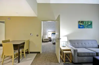 a living room with a couch and a table at Home2 Suites By Hilton Maumee Toledo in Maumee