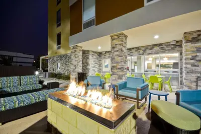a living room with a fire pit in the middle at Home2 Suites By Hilton Maumee Toledo in Maumee