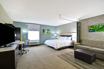 a hotel room with a bed and a desk at Home2 Suites By Hilton Maumee Toledo in Maumee
