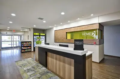 a store lobby with a home sign on a counter at Home2 Suites By Hilton Maumee Toledo in Maumee