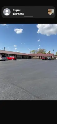 a picture of a parking lot in front of a building at Deluxe Inn in Hebron