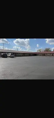 a view of a parking lot with cars parked at Deluxe Inn in Hebron