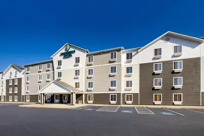 a large building with a sign on top of it at WoodSpring Suites Columbus Southeast in Groveport