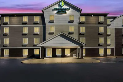 a rendering of a hotel with a large building at WoodSpring Suites Columbus Southeast in Groveport