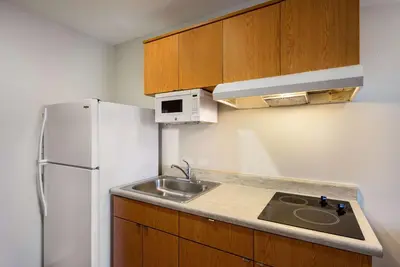 a small kitchen with a sink and a refrigerator at WoodSpring Suites Columbus Southeast in Groveport
