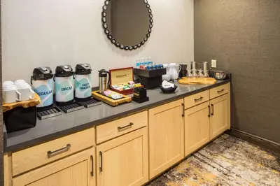 a room with a counter with a lot of products on it at Hilton Garden Inn Pittsburgh Airport in Moon Township