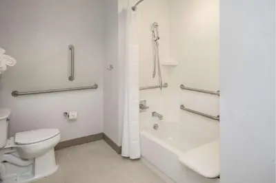 a bathroom with a toilet and a tub and a sink at Hilton Garden Inn Pittsburgh Airport in Moon Township