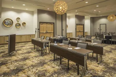 a restaurant with tables and chairs in a room at Hilton Garden Inn Pittsburgh Airport in Moon Township