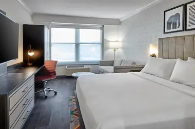 a hotel room with a large bed and a television at Hotel Indigo Cleveland Downtown by IHG in Cleveland
