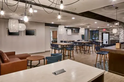 a restaurant with tables and chairs and a bar at Hotel Indigo Cleveland Downtown by IHG in Cleveland