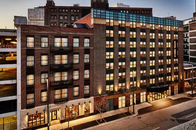 a large brick building with many windows in a city at Hotel Indigo Cleveland Downtown by IHG in Cleveland