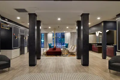 a lobby with columns and a red couch at Hotel Indigo Cleveland Downtown by IHG in Cleveland