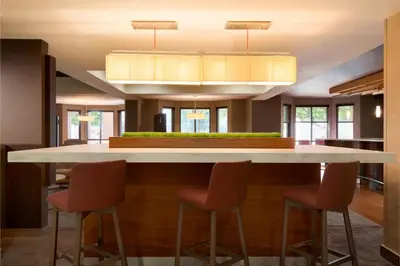 a kitchen with a large island with bar stools at Courtyard Akron Fairlawn in Montrose
