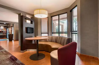 a living room with a table and a couch at Courtyard Akron Fairlawn in Montrose