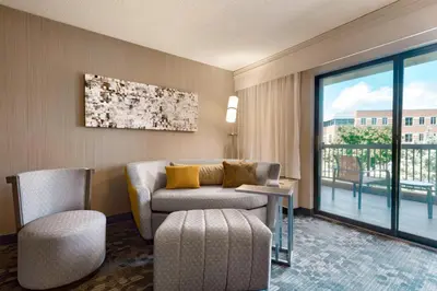 a living room with a couch and a chair and a window at Courtyard Akron Fairlawn in Montrose