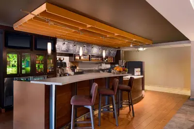 a bar in a restaurant with bar stools at Courtyard Akron Fairlawn in Montrose