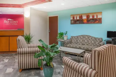 a waiting room with two chairs and a couch at Baymont by Wyndham Greensburg in Greensburg