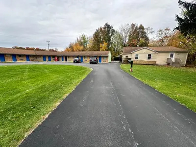 a street with cars parked on the side of a house at Westgate Manor Motel Austintown & Youngstown OHIO in Youngstown