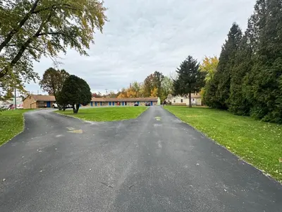 an empty road with a building in the distance at Westgate Manor Motel Austintown & Youngstown OHIO in Youngstown