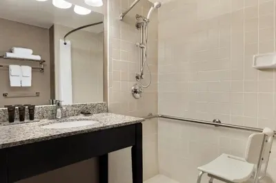 a bathroom with a sink and a shower at Wingate by Wyndham Cincinnati Blue Ash in Blue Ash