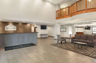 a lobby of a hotel with a waiting room at Wingate by Wyndham Cincinnati Blue Ash in Blue Ash