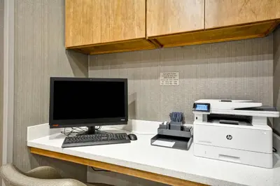 a desk with a computer and a printer on it at SpringHill Suites by Marriott Cincinnati Blue Ash in Blue Ash