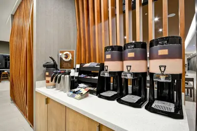 a counter with a bunch of wine bottles on it at SpringHill Suites by Marriott Cincinnati Blue Ash in Blue Ash