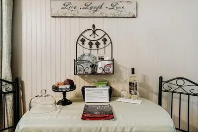 a room with a bed with a table with a shelf at Hocking Hills Inn in Logan