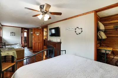 a bedroom with a bed and a ceiling fan at Hocking Hills Inn in Logan