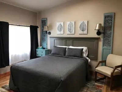 a bedroom with a bed and a chair at Hocking Hills Inn in Logan