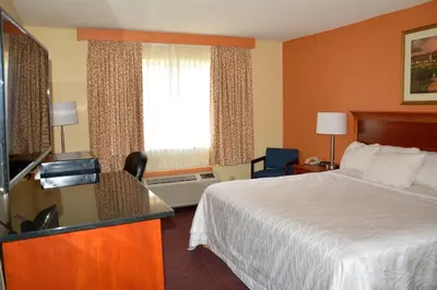 a hotel room with a bed and a window at Columbus Grand Hotel & Banquet Center in Columbus