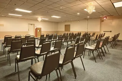 an empty room with chairs in a classroom at Columbus Grand Hotel & Banquet Center in Columbus