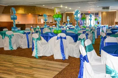 a banquet hall with blue and white tables and chairs at Columbus Grand Hotel & Banquet Center in Columbus