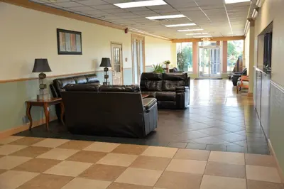 a living room with couches and chairs in a room at Columbus Grand Hotel & Banquet Center in Columbus