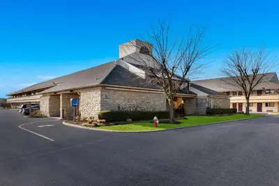 a large brick building with a fire hydrant in front of it at Rodeway Inn Columbus West in Columbus